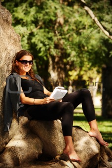 Young woman reading in the park