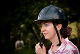 Costa Rican tourist putting on equestrian helmet