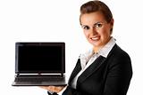 smiling modern business woman holding laptop in hand
