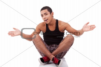 young man with open arms, sitting on floor, isolated on white, studio shot