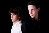 two young back to back, isolated on black, studio shot
