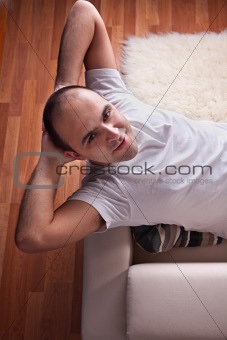Happy man lying relaxed on the couch
