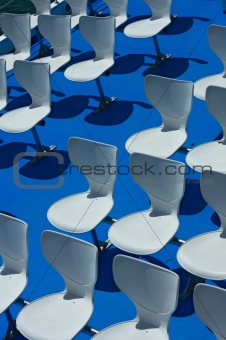 White Plastic Chairs on Blue Deck
