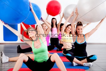 people doing stretching exercise with fitness balls
