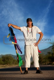 Man in the middle of a road with flags