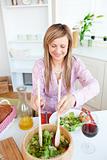Radiant woman eating salad in the kitchen