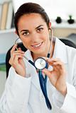 Hispanic female doctor holding a stethoscope