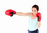 Athletic hispanic woman with boxing gloves working out