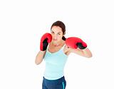 Concentrated hispanic woman with boxing gloves working out