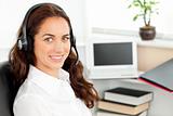 Delighted hispanic businesswoman with headset