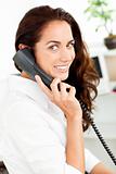 Positive hispanic businesswoman talking on phone