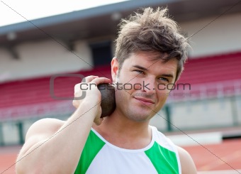 Concentrated male athlete preparing to throw weight