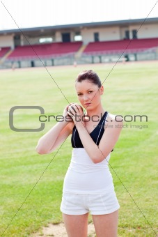 Concentrated female athlete holding weight