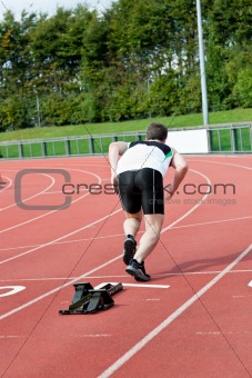 Athletic man running in a stadium