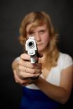 Woman aiming a gun