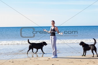 Young sporty woman surrounded by two dogs