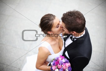 Young married couple kiss