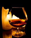candles and a glass of brandy