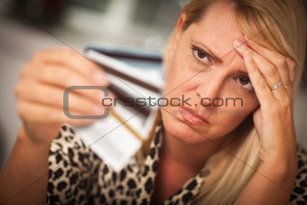 Upset Robed Woman Glaring At Her Many Credit Cards.