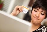 Smiling Multiethnic Woman Holding Credit Card While Using Laptop.