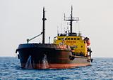 Black tanker is at anchor near the port