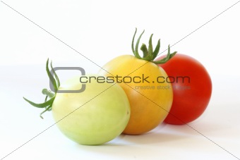 Three tomatoes colorful tomatoes on white background