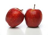 A pair of red apples with drops