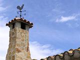 stone chimney with weathervane