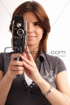 Young woman holding an old movie camera