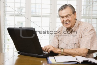 Mature man with laptop.