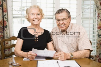 Mature couple with bills.