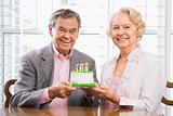 Mature couple with cake.