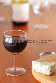 Glass of wine with bottle 