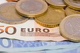 Euro coins on bank notes