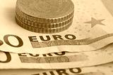 Euro coins on bank notes