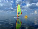 Windsurfer and its reflection in water of a gulf 