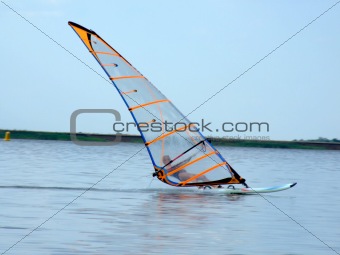 windsurfer on waves of a gulf in the afternoon
