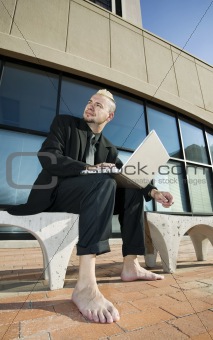 Barefoot Punk Businessman with his Laptop Computer
