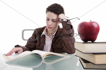 cute boy studying and thinking, along with one on apple top of some books
