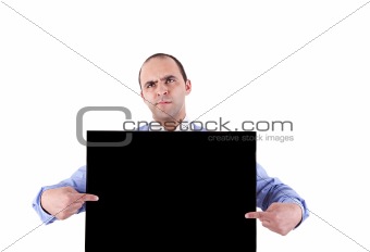 young business man holding a blackboard and pointing with both hands, looking bored