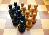 Vintage black and white pawns on chess board