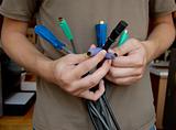 IT specialist holds in his hands a bouquet of the cables