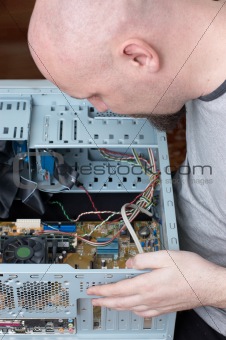 IT specialist repairing computer system unit