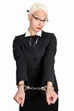 Young business woman with handcuffs on her hands. 
