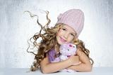 winter fashion cap little girl hug teddy bear smiling