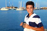 binoculars teenager boy on boat marina