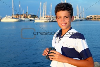 binoculars teenager boy on boat marina