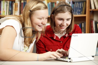 Teen Girls Use Computer in Library