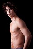 a sweat  young man in topless, isolated on black. Studio shot.