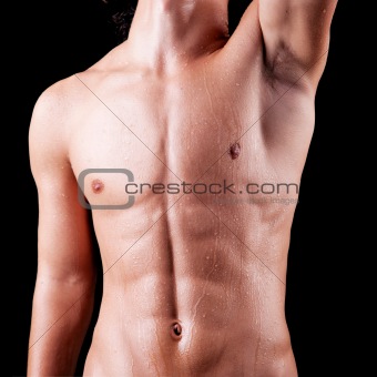 torso of a sweat man in topless, isolated on black. Studio shot.
